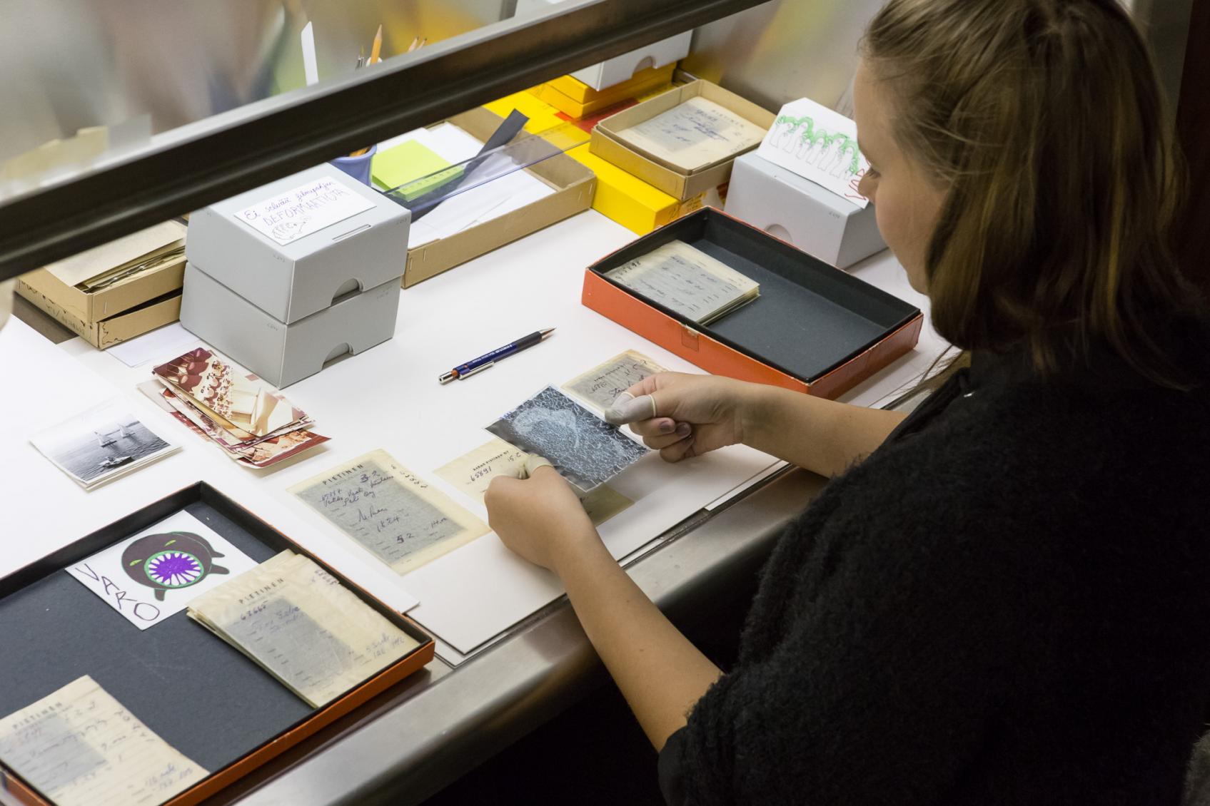Conservator Karoliina Valli working on the Pietinen Collection original negatives. Photo: Virve Laustela, The Finnish Museum of Photography.